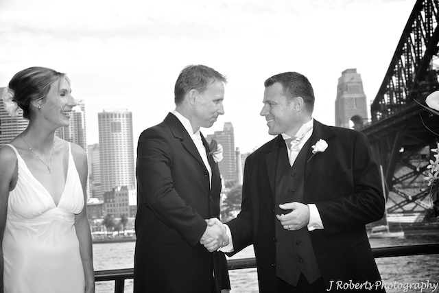 Couple congratulated by best man - wedding photography